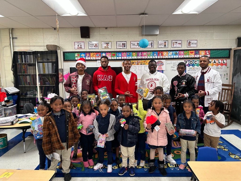 Brothers and students at classroom holiday celebration